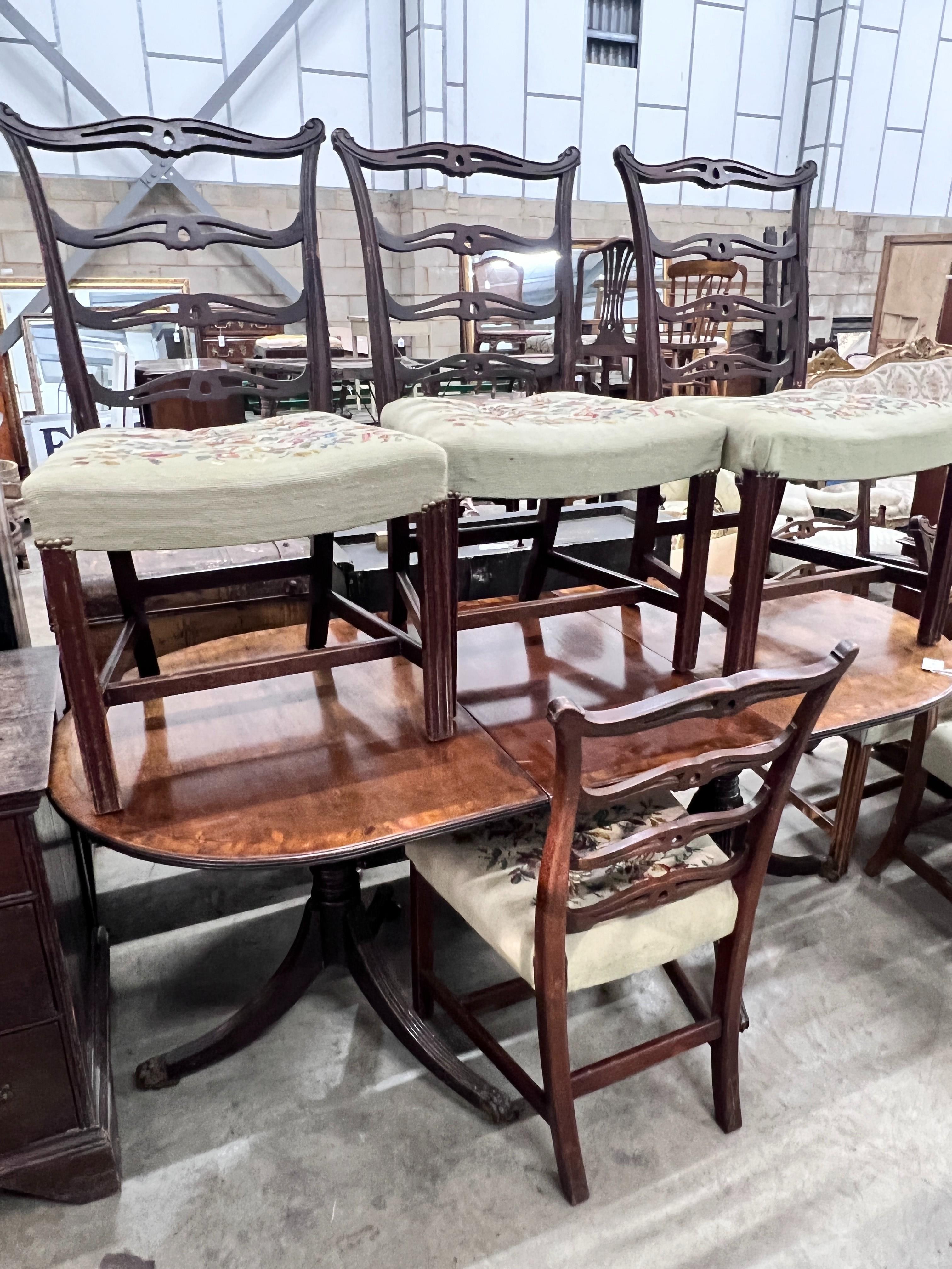 A 19th century and later D end extending dining table 176cm extended 1 spare leaf and six George III style pierced ladderback chairs, 2 with arms.